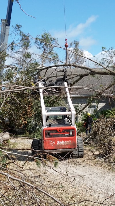 Arbormax crane removes part of a tree that had fallen on a home during Hurricane Michael.