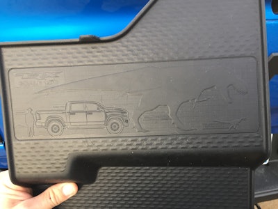 Center console liner shows a T-Rex chasing down a tiny velociraptor.