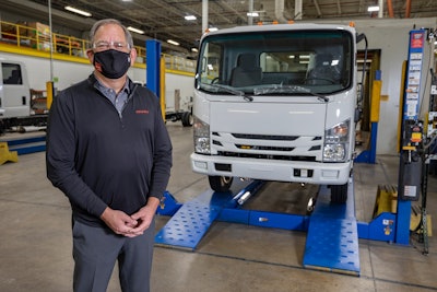 sean skinner, Isuzu Commercial Truck of Canada president, in front of Isuzu truck