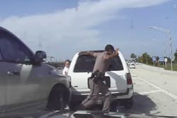 Twenty-three year-old Florida State Trooper Dominic Alexandre is shown in this screenshot dashing out of the way of a pickup that nearly struck him last week in Palm Beach County on Interstate 95.