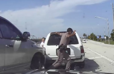 Twenty-three year-old Florida State Trooper Dominic Alexandre is shown in this screenshot dashing out of the way of a pickup that nearly struck him last week in Palm Beach County on Interstate 95.