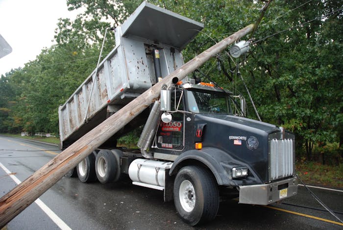 Police say this dump truck was traveling with a raised bed when it brought down power lines this week in Manchester Township, N.J.