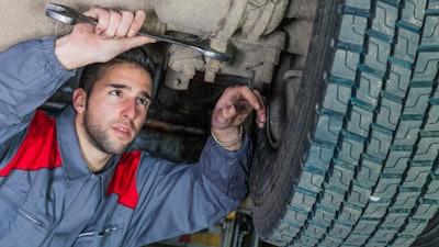 Technician working under truck