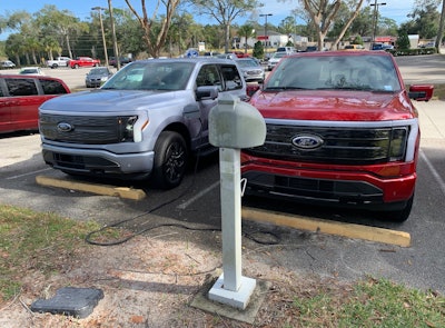 Two 2022 F-150 Ford Lightnings at Coggins Ford in Deland, Florida.